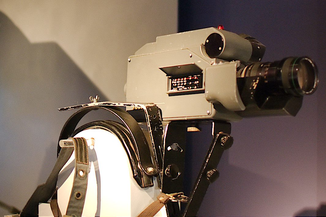 An early grey Ikegami HL-33 portable colour television camera on a shoulder support.