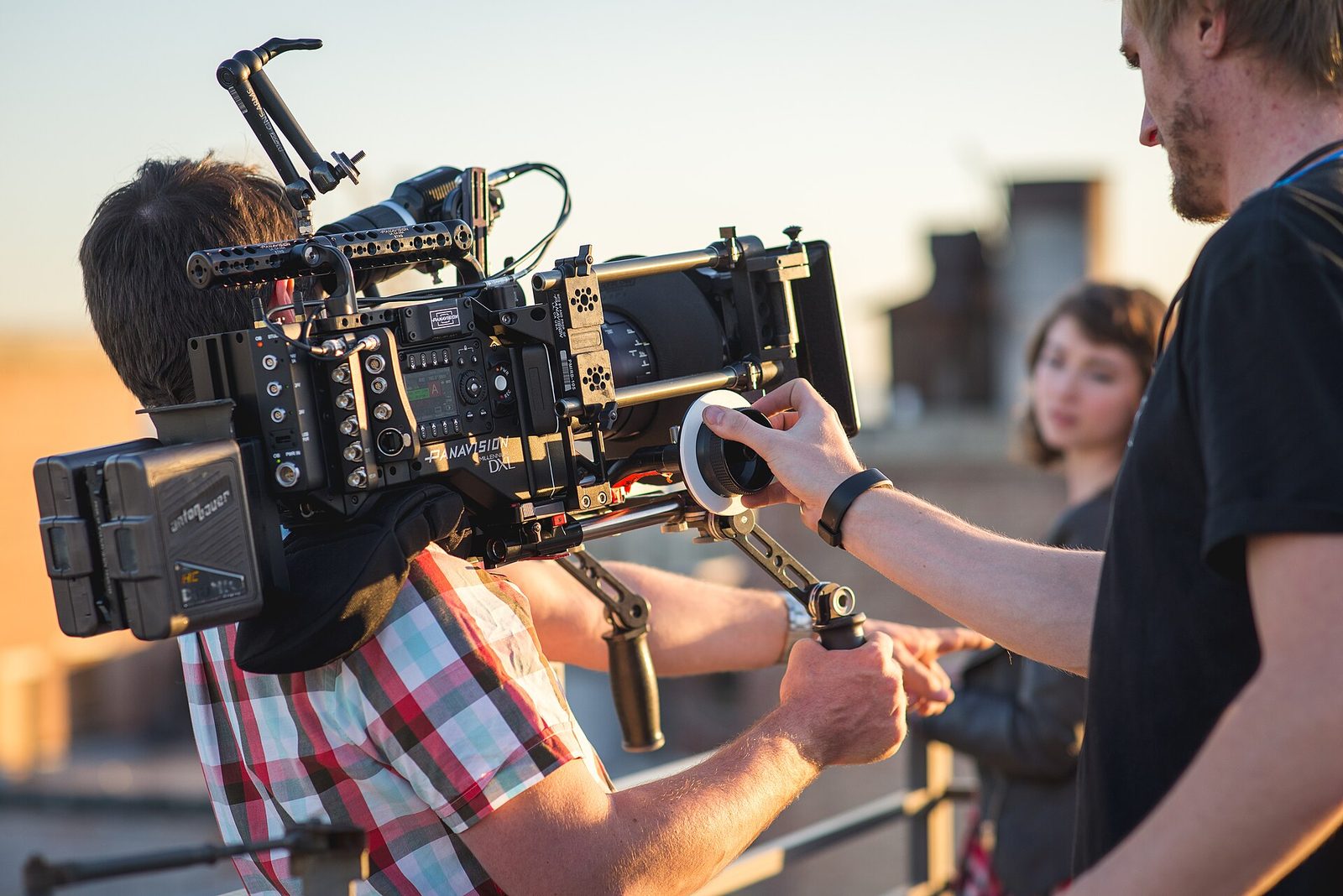 A focus puller adjusting focus on a modern Panavision camera